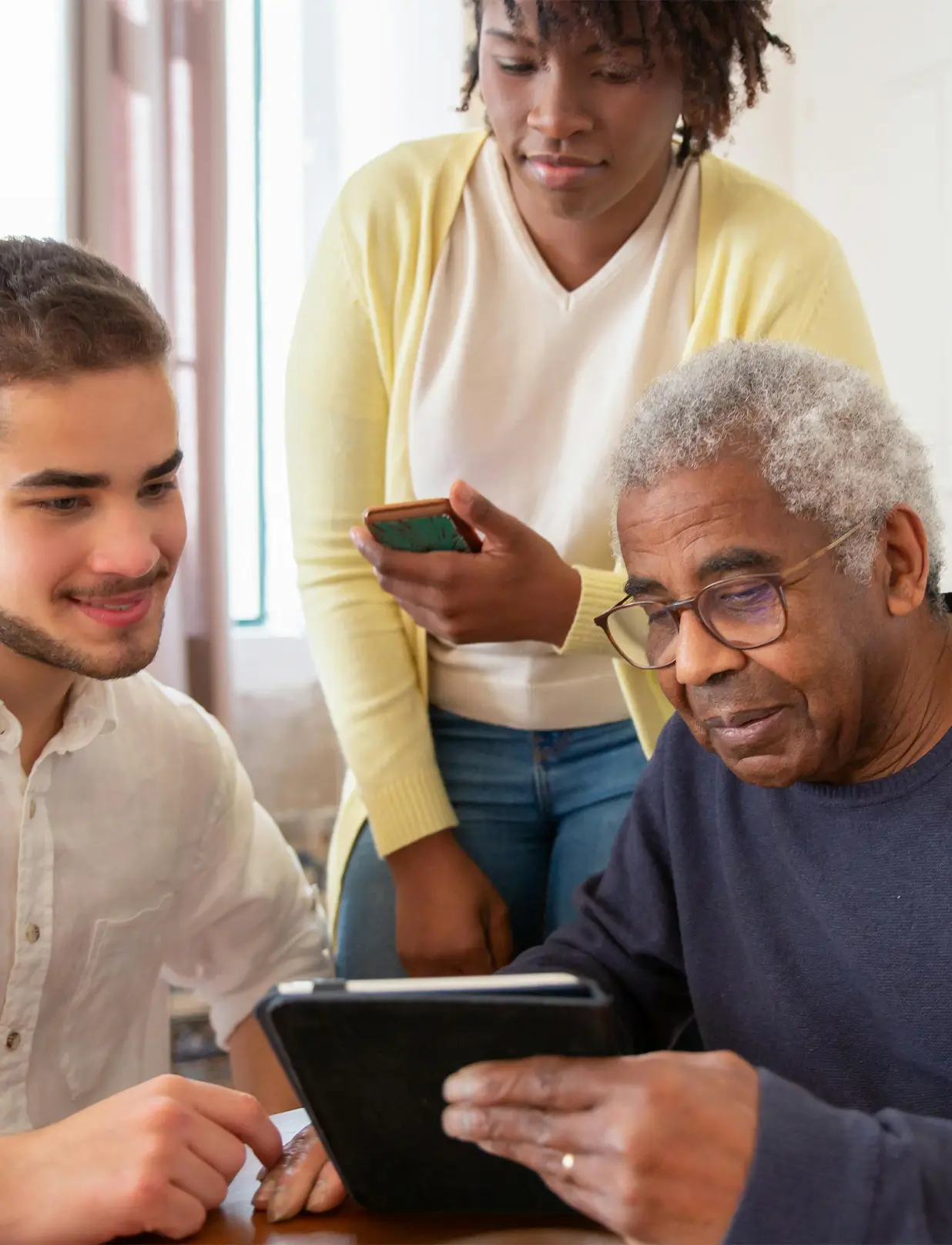 a group of people looking at a tablet