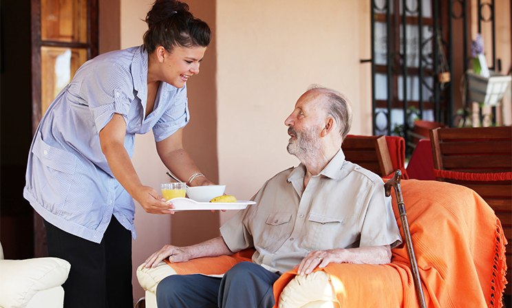 caregiver feeding a man lunch